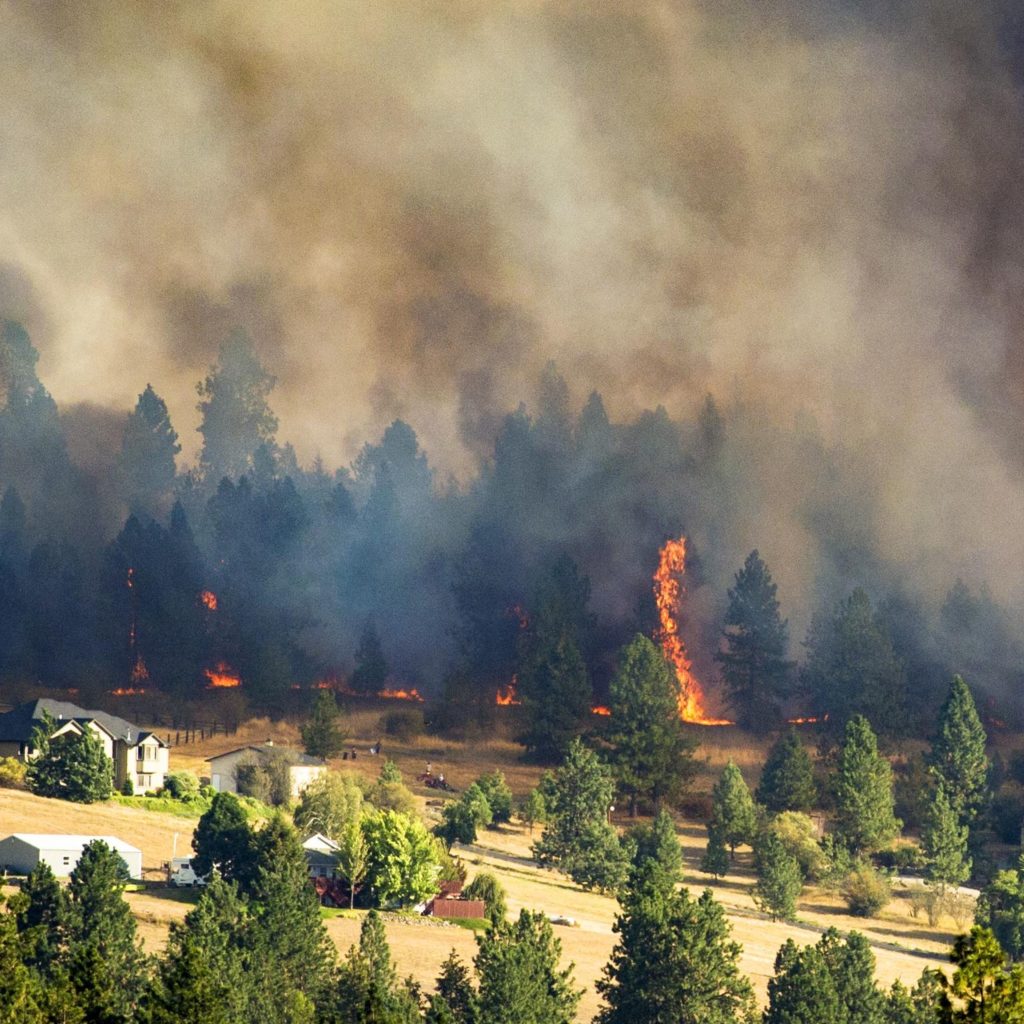A Fast-moving fire approaches a neighborhood in Spokane Valley, Wa during the Beacon Hill Fire in 2019.
